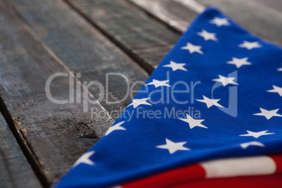 Folded American flag on wooden table