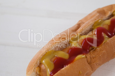 Hot dog on white wooden table