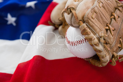 Baseball and gloves on an American flag