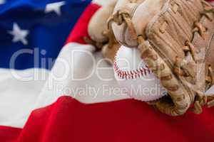 Baseball and gloves on an American flag