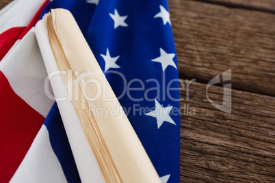 American flag with rolled-up of constitution document