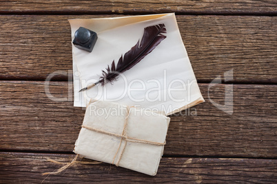 Quill feather, ink pot, and legal documents arranged on table