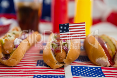 American flag and hot dogs on wooden table