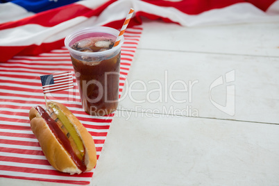 American flag and hot dog on wooden table