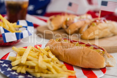 American flag and hot dogs on wooden table