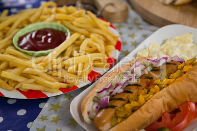 Hot dog and french fries on wooden table with 4th july theme