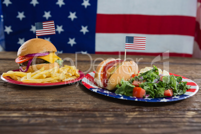 Burger and hot dog on wooden table with 4th july theme