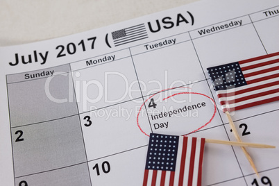 Close-up of American flags arranged on calendar