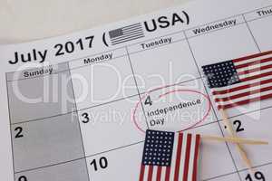 Close-up of American flags arranged on calendar