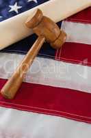 Gavel and rolled-up document arranged on American flag