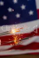 Sparklers burning against American flag background