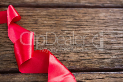 Red ribbon on wooden table