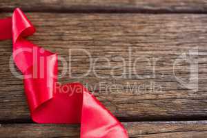 Red ribbon on wooden table