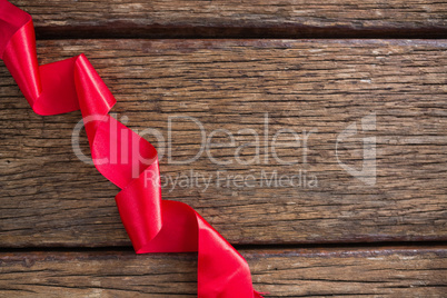 Red ribbon on wooden table