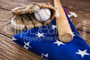 Baseball bat and gloves on an American flag