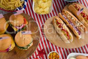 Hot dogs and burgers on wooden table with 4th july theme