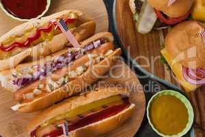 Close-up of hot dogs and hamburgers decorated with 4th july theme