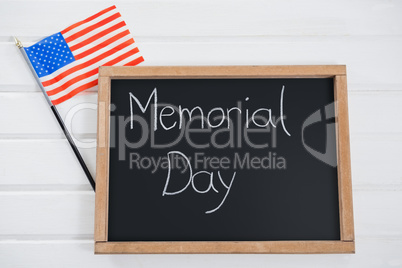Slate with text and an American flag on wooden table