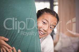 Smiling daughter hugging her father in living room