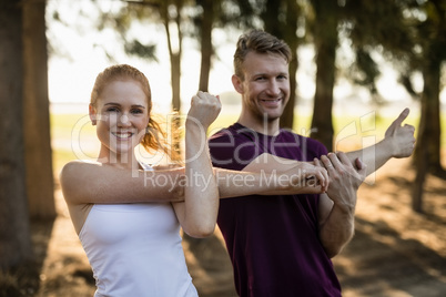 Smiling couple exercising at farm