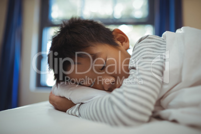 Boy sleeping on the bed in bed room