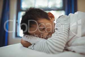 Boy sleeping on the bed in bed room