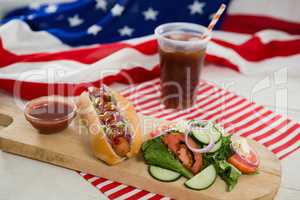 American flag and hot dog on wooden table