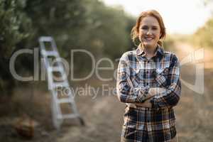 Smiling female standing at farm
