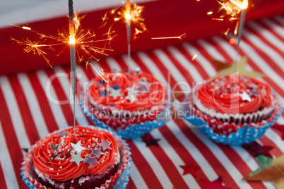 Burning sparkler on decorated cupcakes