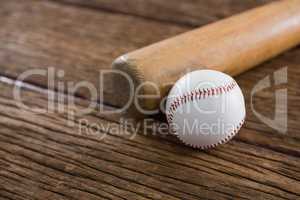 Baseball bat and ball on wooden table