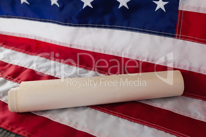 Rolled-up document arranged on American flag