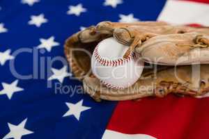 Baseball and gloves on an American flag