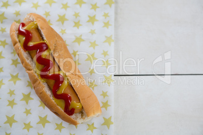 American flag and hot dog on wooden table