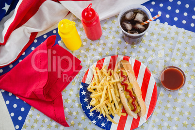 American flag and hot dog on wooden table