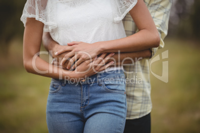 Mid section of couple embracing