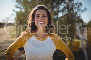 Smiling woman standing at olive farm on sunny day