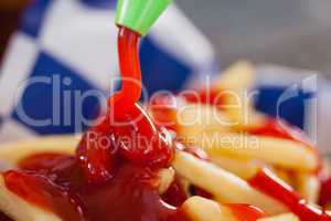 Ketchup falling on french fries