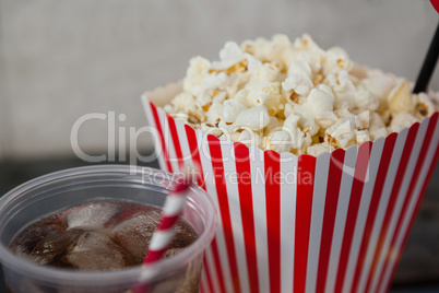 Close-up of popcorn and cold drink