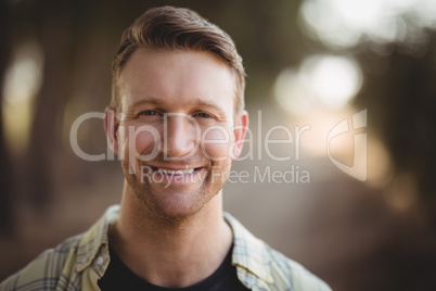 Portrait of smiling young man at olive farm