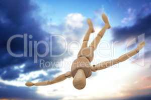 Composite image of wooden 3d figurine lying on floor with arms spread