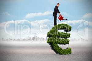 Composite image of businesswoman using red watering can