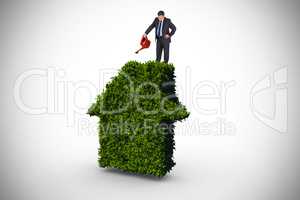 Composite image of mature businessman using watering can