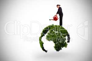 Composite image of businesswoman using red watering can