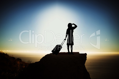 Composite image of silhouette businesswoman with suitcase
