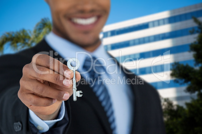 Composite image of mid section of businessman showing new house key