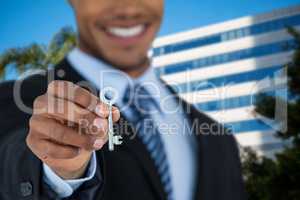 Composite image of mid section of businessman showing new house key
