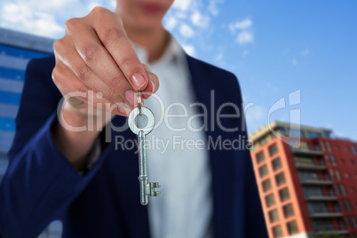 Composite image of mid section of businesswoman showing house key