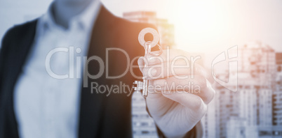 Composite image of mid section of businesswoman showing new house key