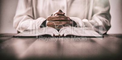 Woman sitting at desk with bible