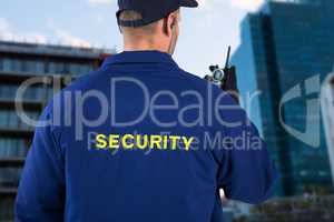 Composite image of rear view of security officer talking on walkie talkie